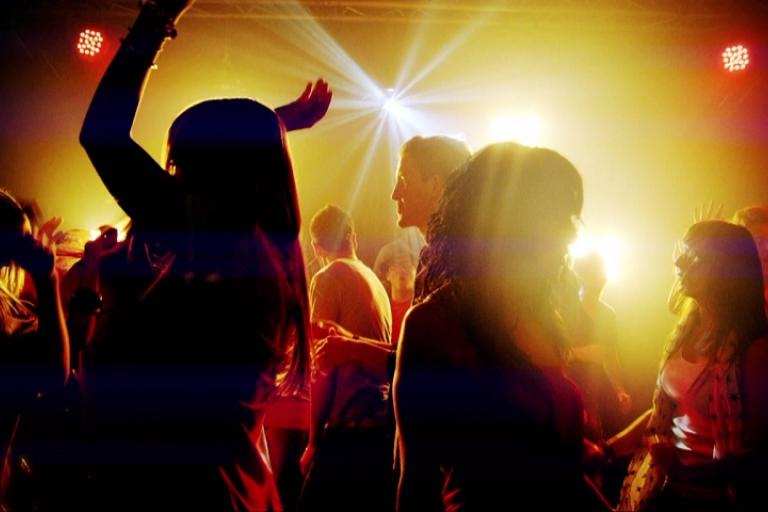 Many people dancing in a club scene