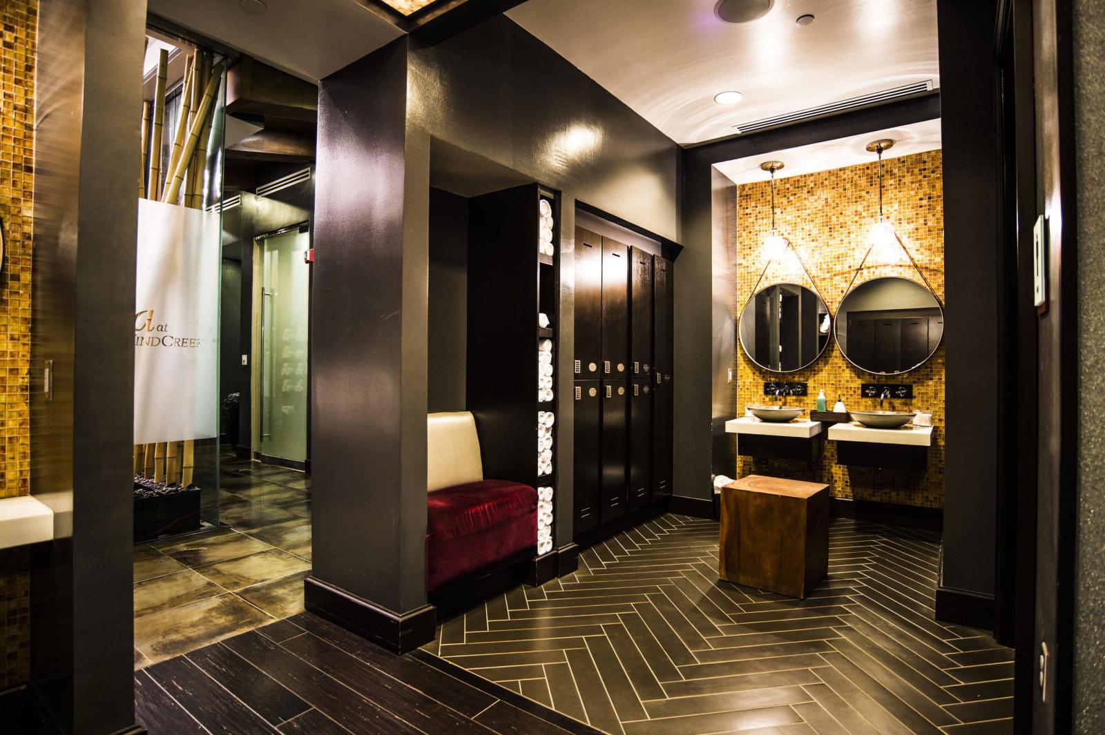 Inside view of the Atmore Spa with lockers, sinks, and seating areas. 