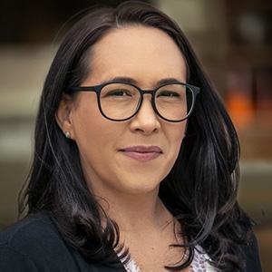 A professional headshot of Mary Rhodes