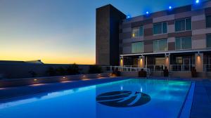 Photo of Wind Creek's outdoor pool with the hotel building in the background