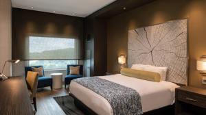 View of a king-sized bed next to a window