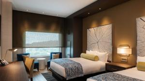 View of two queen-sized beds next to a window