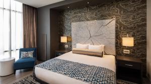 View of a king-sized bed next to a window