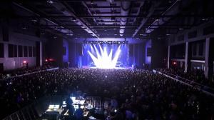 A packed venue with exciting stage lighting 