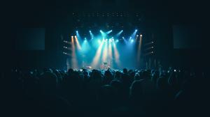 A concert stage with a large crowd enjoying a live music performance