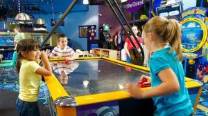 Kids playing air hockey
