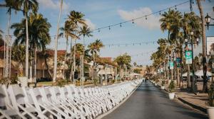 A row of white chairs lined up in the street