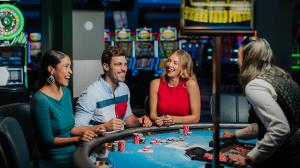Several people gathered around a poker table