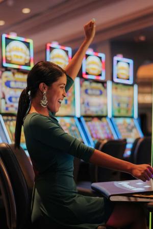 A woman celebrates after winning big on a machine